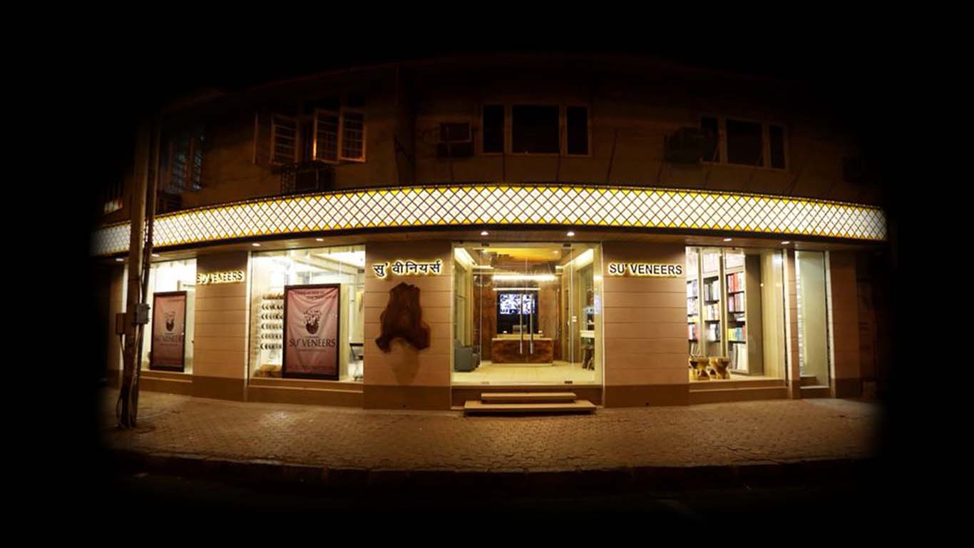 Su'Veneers corner showroom frontage lit at night, published by Su'Veneers